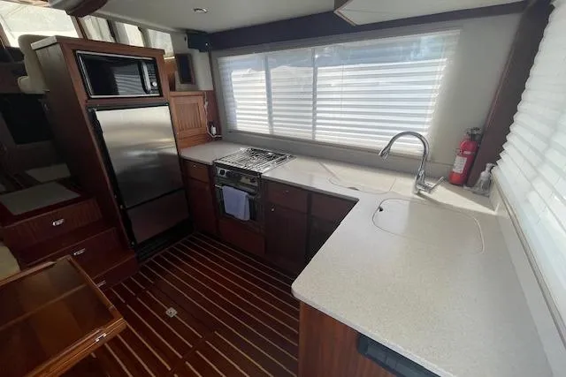 Slide: The Image of Modern kitchen in 2018 American Tug 365 with stainless appliances and wood flooring. - 32