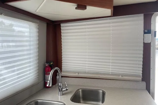 Slide: The Image of Interior of 2018 American Tug 365 with dual sinks and window blinds. - 34