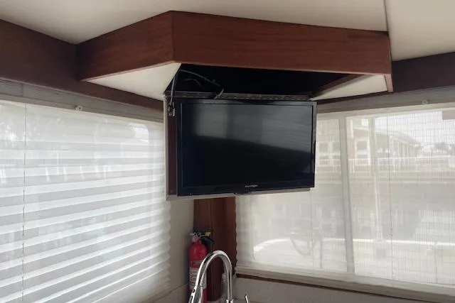 Slide: The Image of Interior of 2018 American Tug 365 with mounted TV and window blinds. - 35