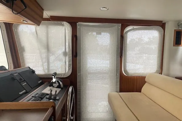 Slide: The Image of Interior of 2018 American Tug 365 with helm, beige seating, and large windows. - 43