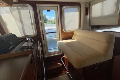 Slide: The Image of Interior of 2018 American Tug 365 with beige seating and large windows. - 45