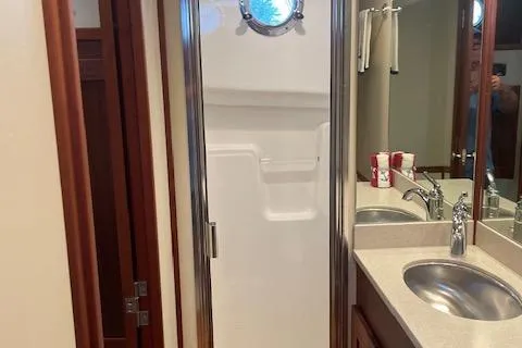 Slide: The Image of Bathroom interior of 2018 American Tug 365 with shower and sink. - 57