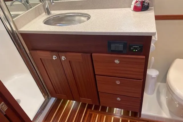 Slide: The Image of 2018 American Tug 365 bathroom with wooden cabinetry and modern fixtures. - 59