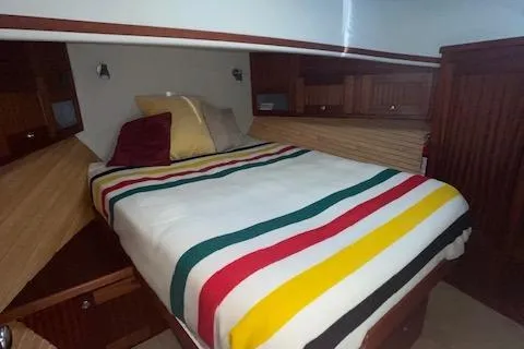 Slide: The Image of Cozy cabin interior of 2018 American Tug 365 with striped bedding and wooden accents. - 64