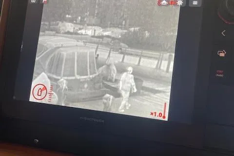 Slide: The Image of Thermal camera view on American Tug 365, 2018 model, showing people on a dock. - 69