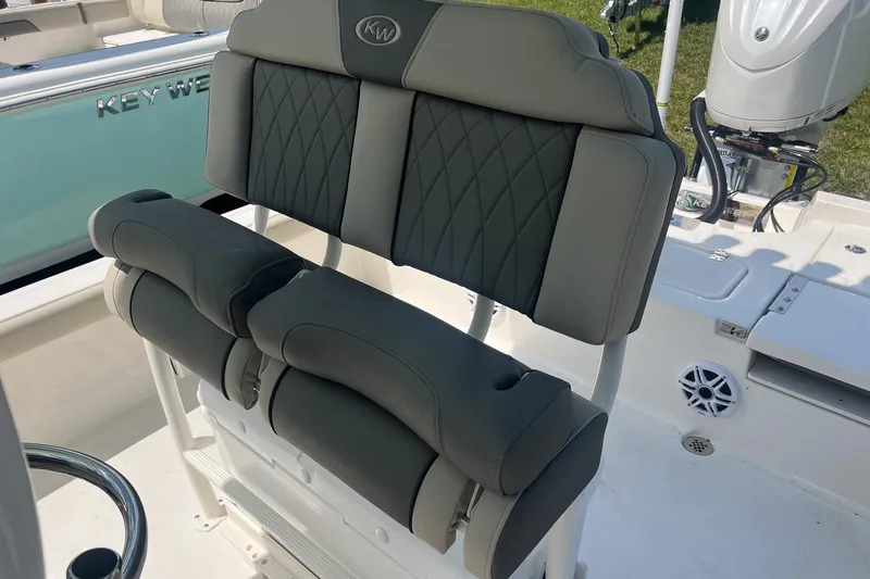 Slide: The Image of 2025 Key West 250 Bay Reef boat with cushioned seating and modern design. - 11