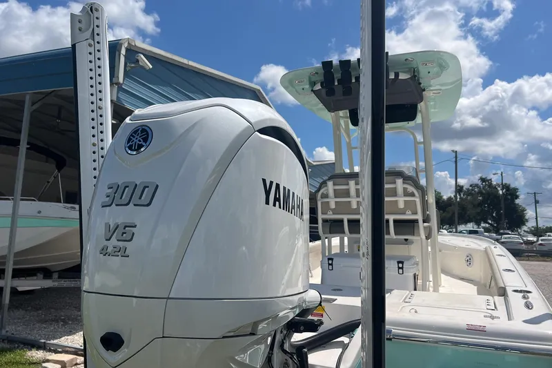 Slide: The Image of 2025 Key West 250 Bay Reef boat with Yamaha 300 V6 engine under blue sky. - 6