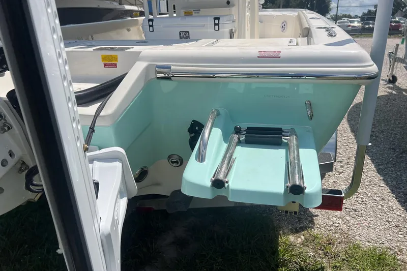 Slide: The Image of 2025 Key West 250 Bay Reef boat with swim ladder and teal accents. - 7