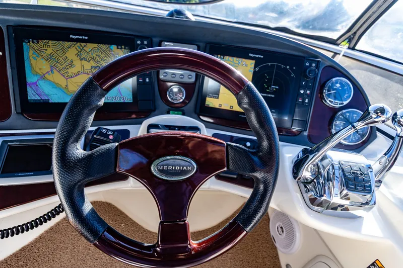 Slide: The Image of 2009 Meridian 391 Sedan helm with navigation screens and controls. - 13