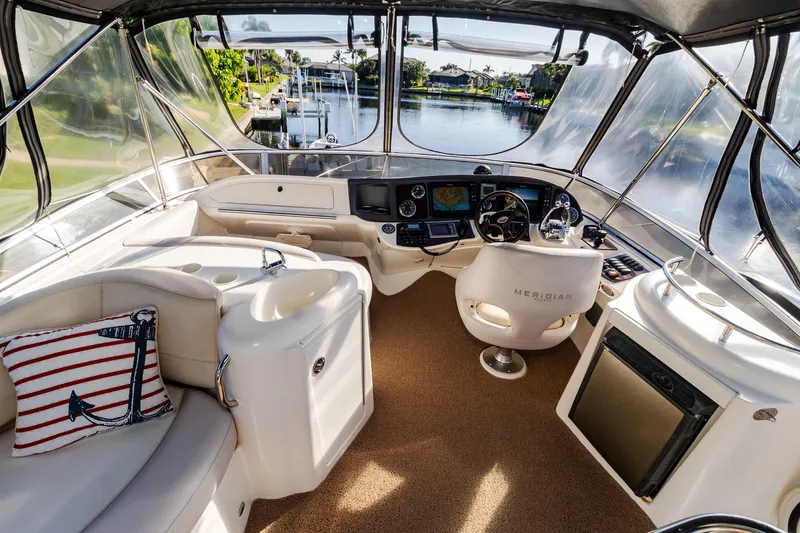 Slide: The Image of Luxurious 2009 Meridian 391 Sedan yacht interior with helm, seating, and scenic waterway view. - 18