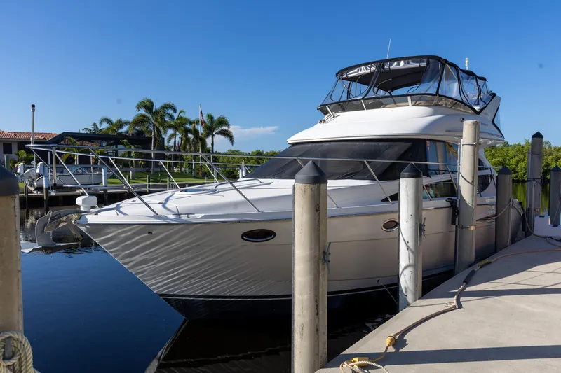 Slide: The Image of 2009 Meridian 391 Sedan yacht docked at marina with clear blue sky. - 2