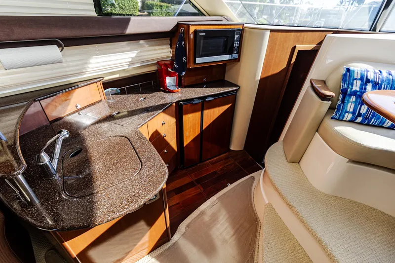 Slide: The Image of Luxurious interior of 2009 Meridian 391 Sedan yacht with kitchenette and seating area. - 22