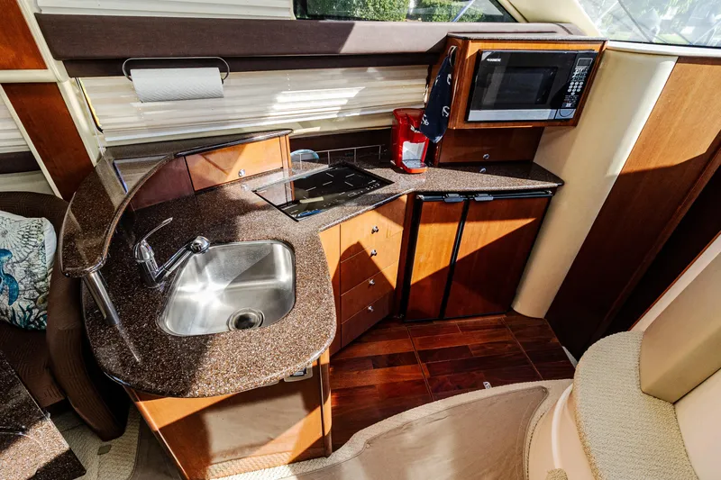 Slide: The Image of Luxurious 2009 Meridian 391 Sedan yacht kitchen with sink, stove, and microwave. - 24