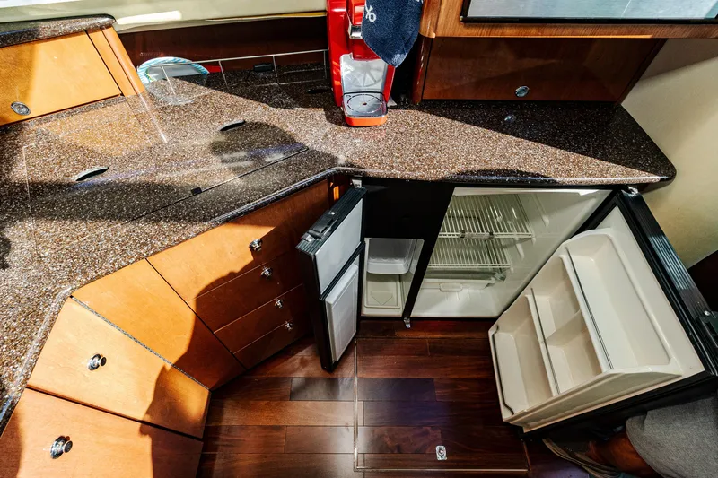Slide: The Image of 2009 Meridian 391 Sedan yacht kitchen with granite countertops and open fridge. - 25