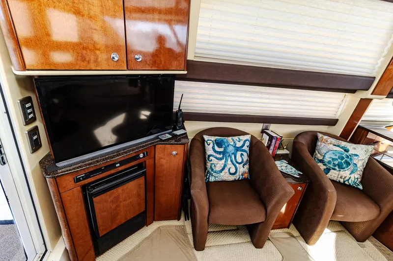 Slide: The Image of Interior of 2009 Meridian 391 Sedan with TV, chairs, and nautical-themed pillows. - 27