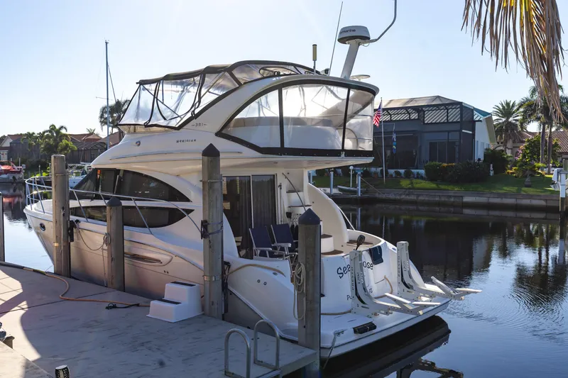 Slide: The Image of 2009 Meridian 391 Sedan yacht docked in a sunny marina setting. - 3