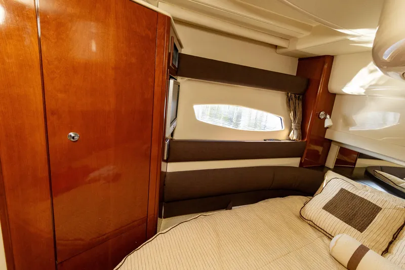 Slide: The Image of Luxurious interior of 2009 Meridian 391 Sedan yacht with cozy bed and wooden cabinetry. - 32