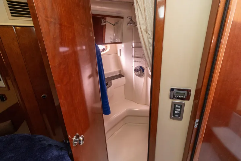 Slide: The Image of 2009 Meridian 391 Sedan yacht bathroom with wooden door and modern fixtures. - 34