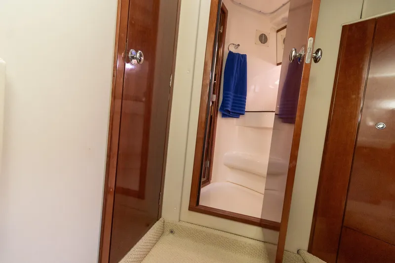 Slide: The Image of Interior of 2009 Meridian 391 Sedan yacht bathroom with wooden doors and blue towel. - 35