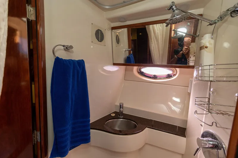 Slide: The Image of 2009 Meridian 391 Sedan yacht bathroom with sink, shower, and blue towel. - 36