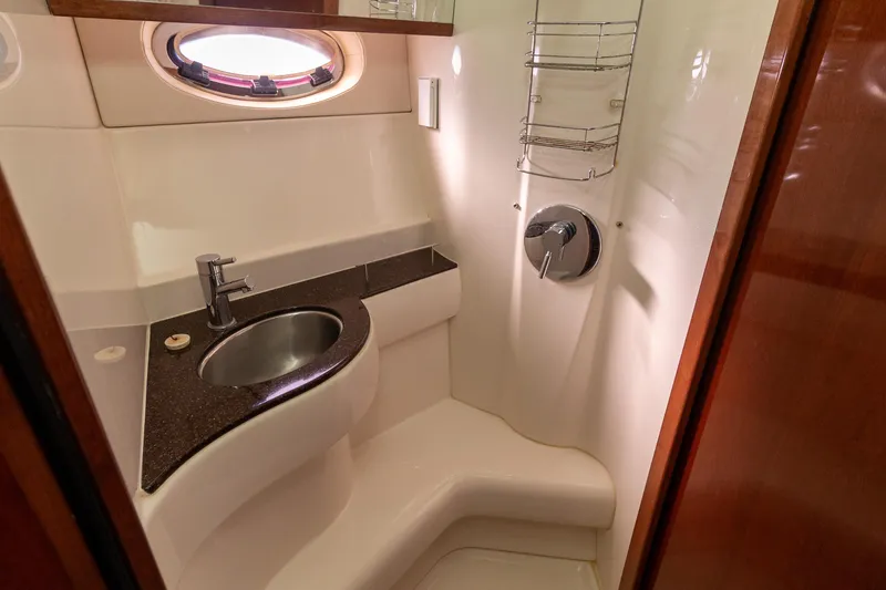 Slide: The Image of Luxurious bathroom in 2009 Meridian 391 Sedan yacht with modern fixtures and porthole window. - 37