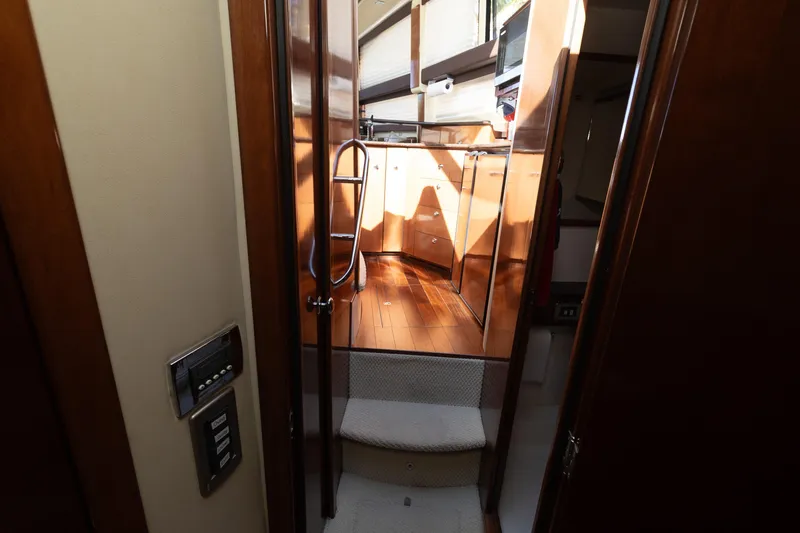 Slide: The Image of Interior view of 2009 Meridian 391 Sedan yacht with wooden cabinetry and carpeted steps. - 40
