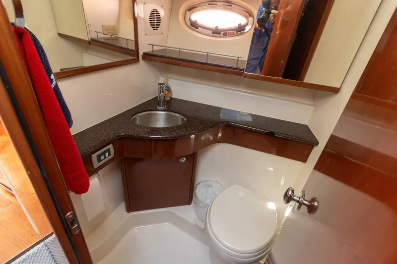 Slide: The Image of 2009 Meridian 391 Sedan yacht bathroom with sink, toilet, and mirror. - 41