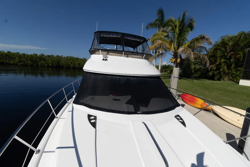 Slide: The Image of 2009 Meridian 391 Sedan yacht docked by lush greenery and calm waters. - 42