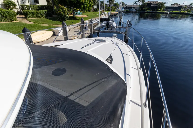 Slide: The Image of 2009 Meridian 391 Sedan yacht docked by a serene waterfront. - 43