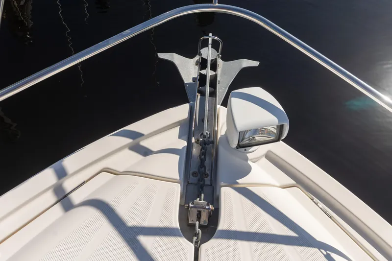 Slide: The Image of Bow of 2009 Meridian 391 Sedan with anchor and spotlight, docked on calm water. - 44