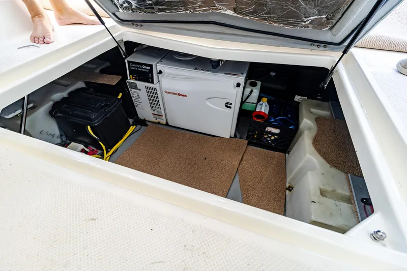 Slide: The Image of 2009 Meridian 391 Sedan engine compartment with Cummins Onan marine generator and battery. - 49