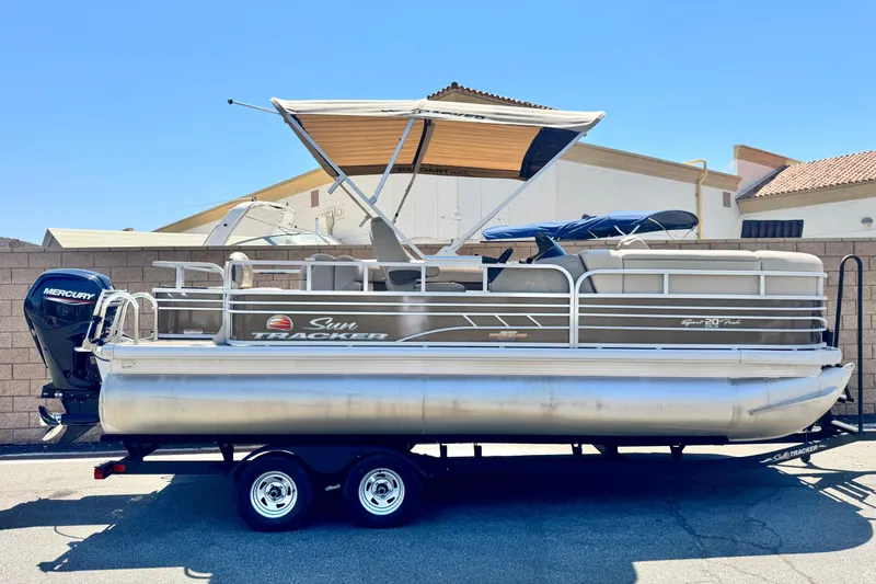 The Image of 2023 Sun Tracker SportFish 20 DLX pontoon boat with Mercury engine on trailer. - 0