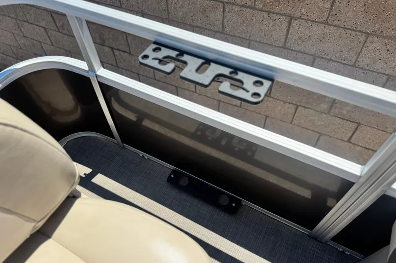 Slide: The Image of 2023 Sun Tracker SportFish 20 DLX interior with beige seating and metal railing. - 18