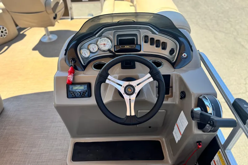 Slide: The Image of 2023 Sun Tracker SportFish 20 DLX boat dashboard with steering wheel and controls. - 21