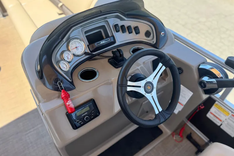 Slide: The Image of 2023 Sun Tracker SportFish 20 DLX boat dashboard with steering wheel and controls. - 22