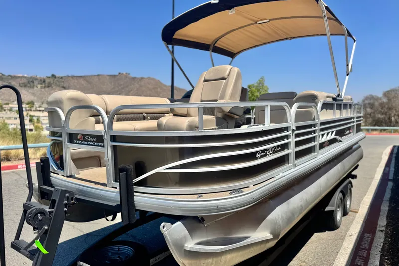 Slide: The Image of 2023 Sun Tracker SportFish 20 DLX pontoon boat with canopy on trailer. - 3