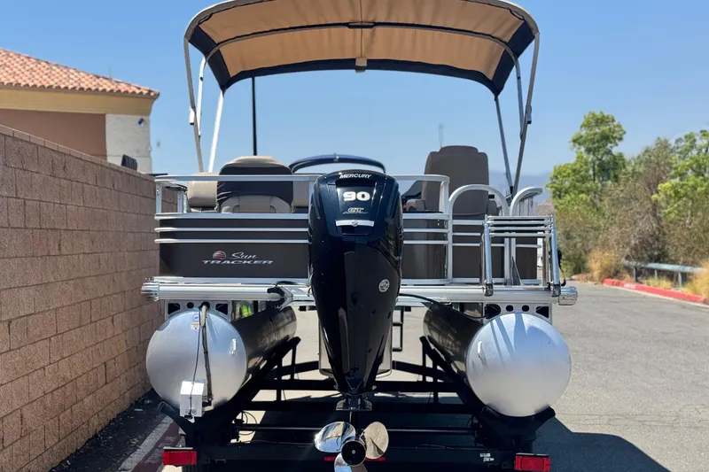 Slide: The Image of 2023 Sun Tracker SportFish 20 DLX pontoon boat with Mercury 90 ELPT engine, parked outdoors. - 5