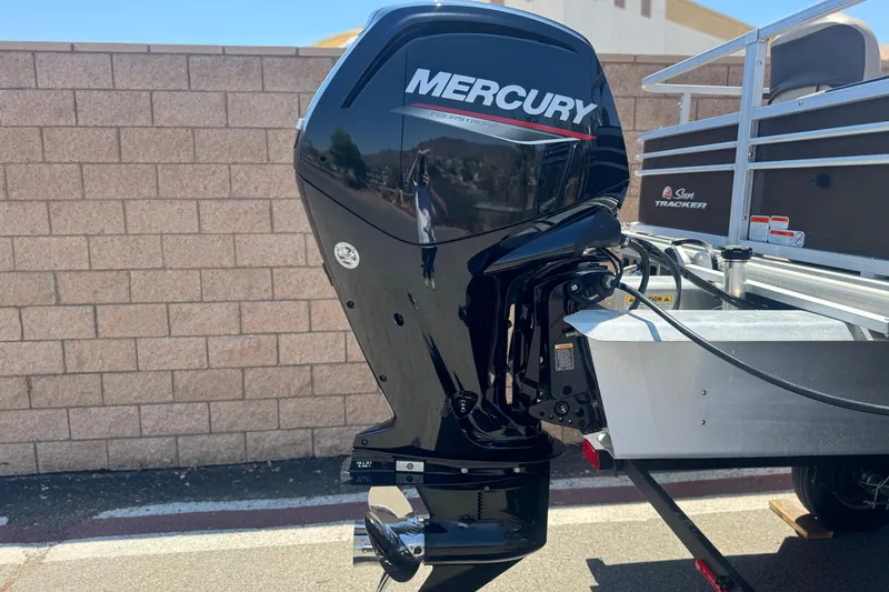 Slide: The Image of 2023 Sun Tracker SportFish 20 DLX with Mercury outboard motor, parked outdoors. - 7