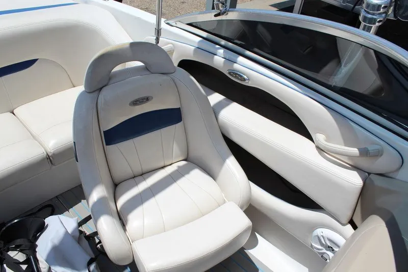 Slide: The Image of Interior of a 2000 Chaparral 196 SSi boat with white seating and blue accents. - 10