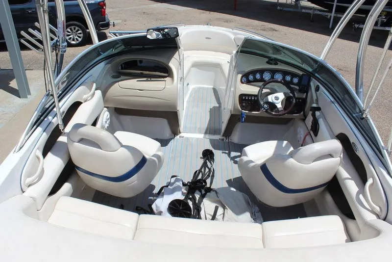 Slide: The Image of Interior of a 2000 Chaparral 196 SSi boat with white seating and dashboard. - 13