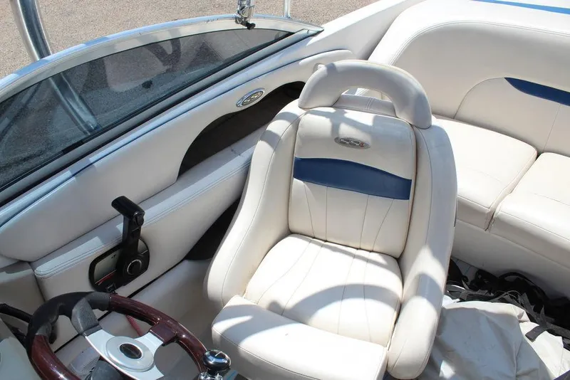 Slide: The Image of Interior of 2000 Chaparral 196 SSi boat with white seating and steering wheel. - 16