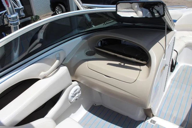 Slide: The Image of Interior view of a 2000 Chaparral 196 SSi boat, featuring beige dashboard and seating. - 17