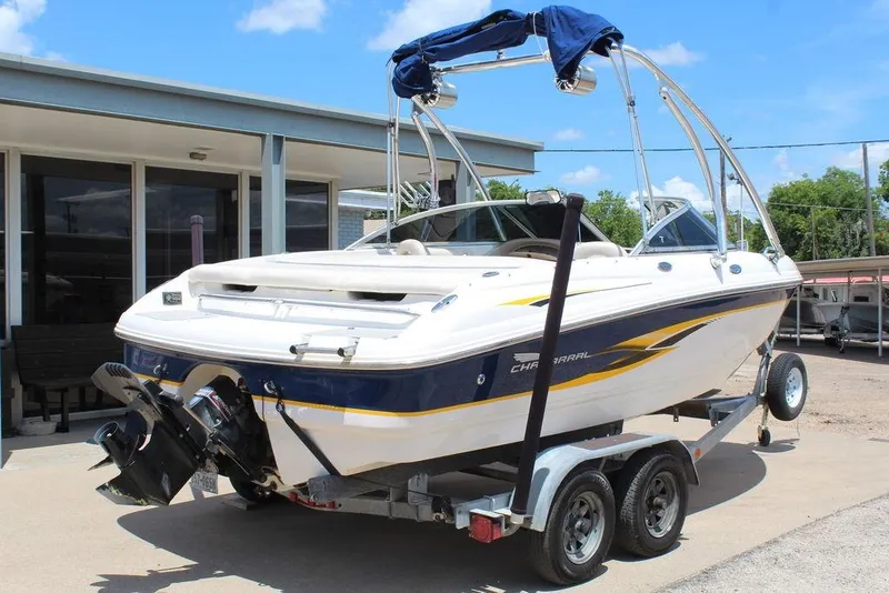 Slide: The Image of 2000 Chaparral 196 SSi boat on trailer, parked outdoors under clear blue sky. - 3