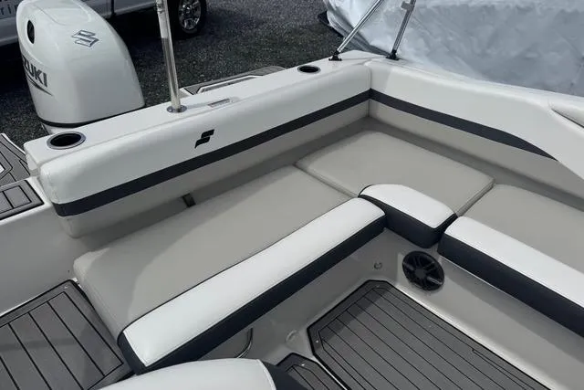 Slide: The Image of 2024 Starcraft SVX 191 OB boat interior with cushioned seating and Suzuki outboard motor. - 6