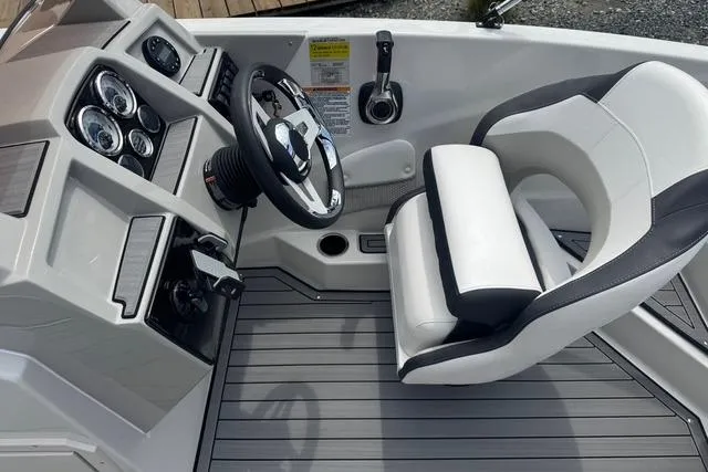 Slide: The Image of 2024 Starcraft SVX 191 OB boat cockpit with steering wheel and gauges. - 7
