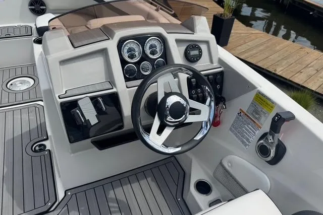 Slide: The Image of 2024 Starcraft SVX 191 OB boat dashboard with steering wheel and control panel. - 8