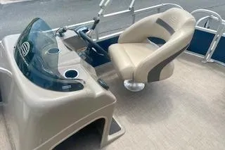 Slide: The Image of 2021 Sun Tracker Party Barge 18 DLX interior with steering console and captain's chair. - 10