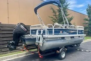 Slide: The Image of 2021 Sun Tracker Party Barge 18 DLX pontoon boat on trailer, parked outdoors. - 4