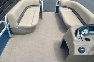 Slide: The Image of 2021 Sun Tracker Party Barge 18 DLX interior with beige seating and control panel. - 7
