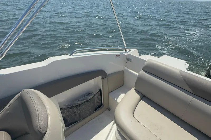 Slide: The Image of 2017 Bayliner 190 Deck Boat interior with seating, on open water. - 10